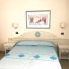 Camera con letto matrimoniale e copriletto azzurro.