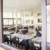 Ristorante con tavoli apparecchiati e vetrate.